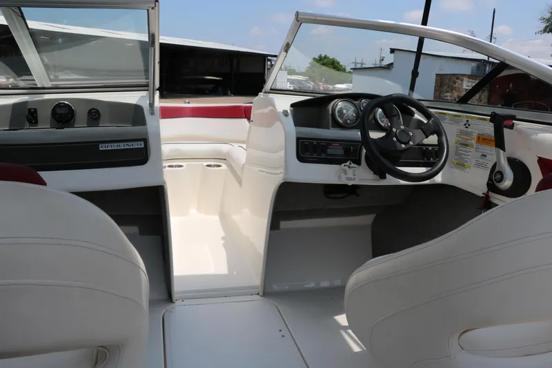 Slide: The Image of Interior view of 2014 Bayliner 185 BR boat, featuring steering wheel and dashboard controls. - 21