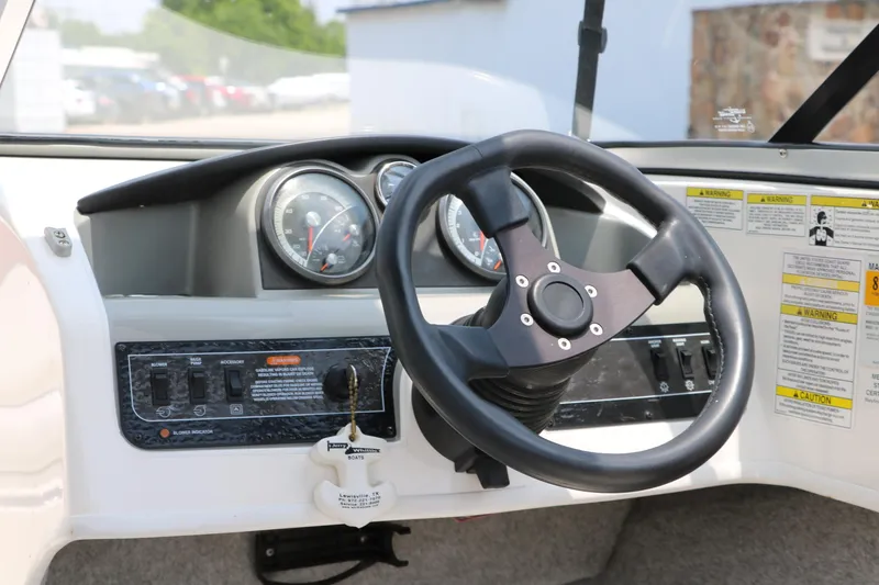 Slide: The Image of Steering wheel and dashboard of a 2014 Bayliner 185 BR boat. - 23