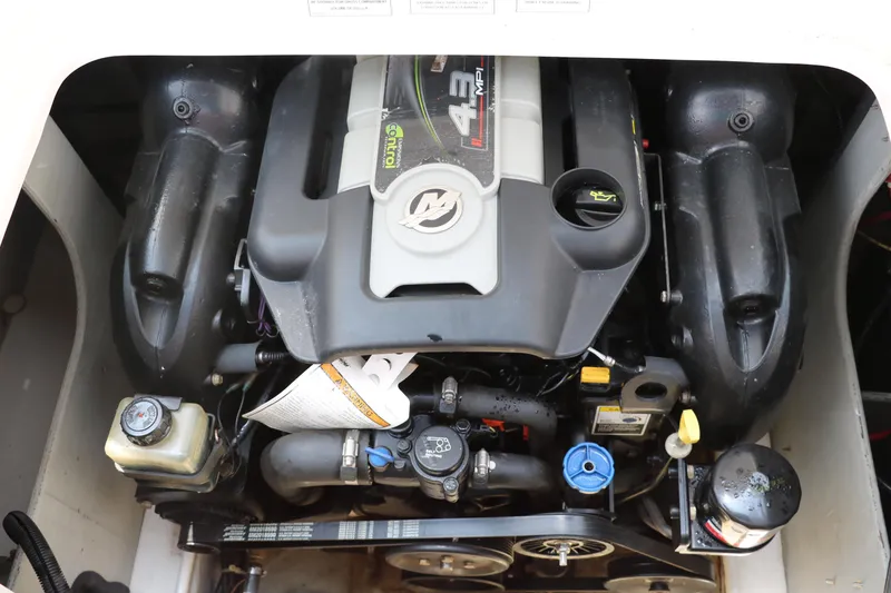 Slide: The Image of 2014 Bayliner 185 BR engine compartment showcasing a powerful inboard motor. - 25