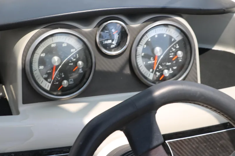 Slide: The Image of Dashboard of a 2014 Bayliner 185 BR boat with speedometer and tachometer. - 26