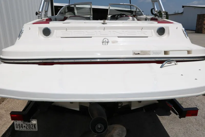 Slide: The Image of 2014 Bayliner 185 BR boat rear view, showcasing sleek design and dual seating. - 5