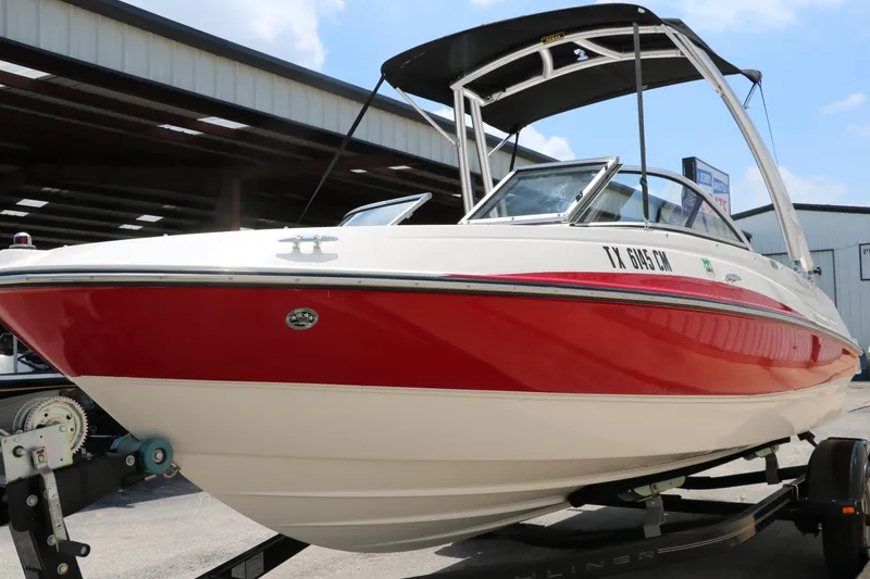 Slide: The Image of 2014 Bayliner 185 BR boat with red and white hull on a trailer. - 9
