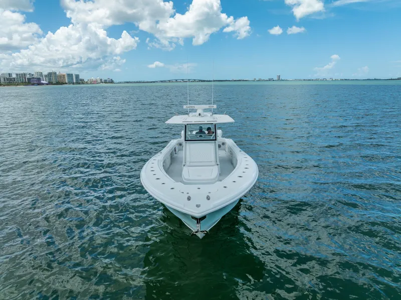 Slide: The Image of 2023 Yellowfin 39 Offshore boat on open water under a partly cloudy sky. - 11