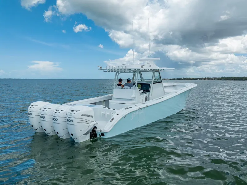 Slide: The Image of 2023 Yellowfin 39 Offshore boat with four engines on open water under a cloudy sky. - 12