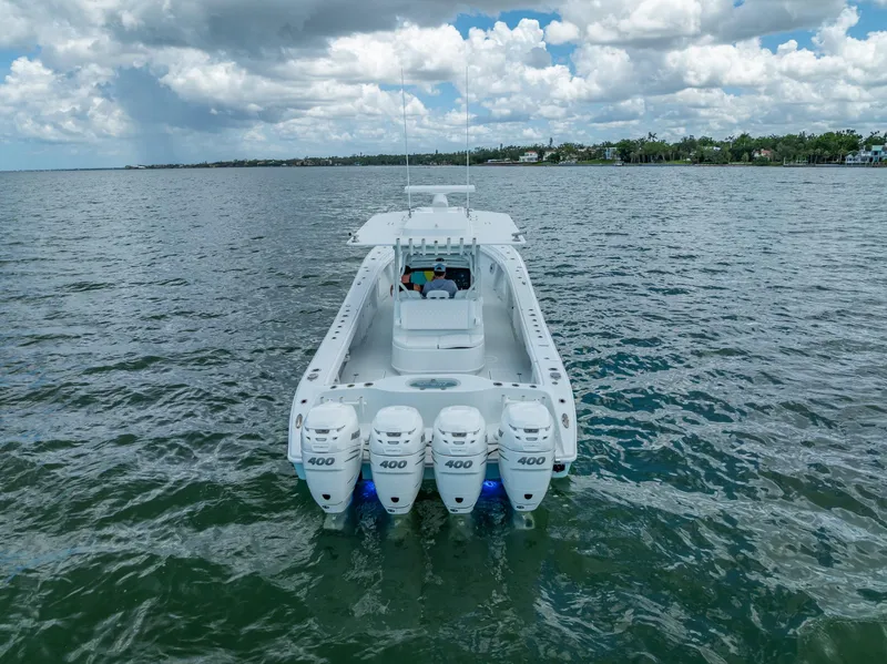 Slide: The Image of 2023 Yellowfin 39 Offshore boat with four powerful engines on open water. - 14