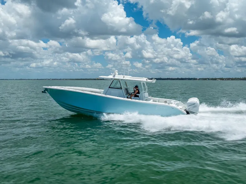 Slide: The Image of 2023 Yellowfin 39 Offshore boat cruising on open water under a cloudy sky. - 16