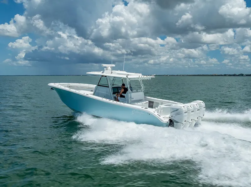 Slide: The Image of 2023 Yellowfin 39 Offshore boat cruising on open water under a cloudy sky. - 17