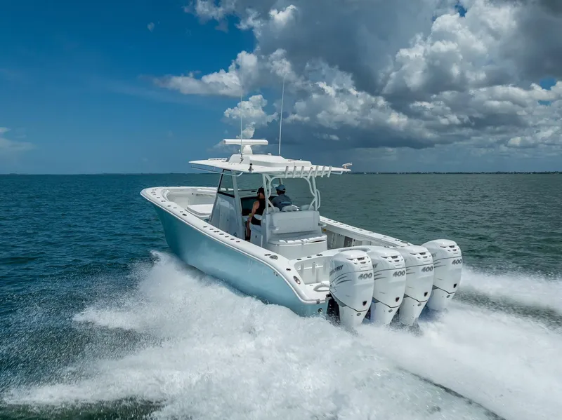 Slide: The Image of 2023 Yellowfin 39 Offshore boat cruising on open water under a cloudy sky. - 18