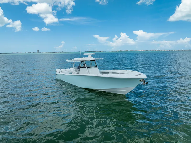 Slide: The Image of 2023 Yellowfin 39 Offshore boat on open water under blue sky. - 2