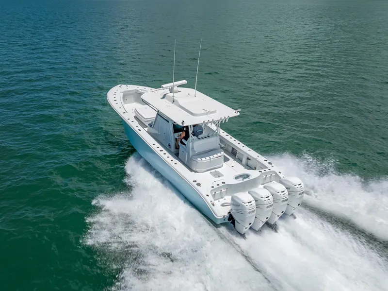 Slide: The Image of 2023 Yellowfin 39 Offshore boat cruising on open water with four powerful engines. - 20