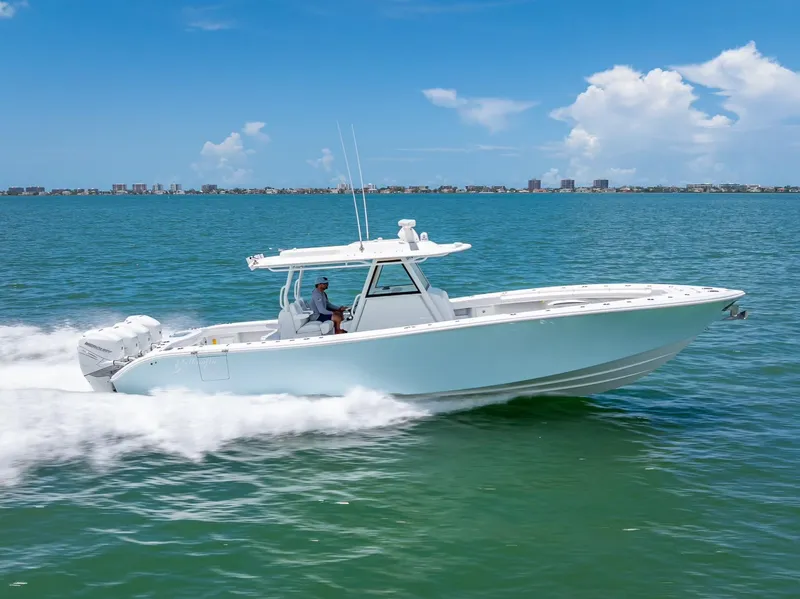 Slide: The Image of 2023 Yellowfin 39 Offshore boat cruising on open water under a clear blue sky. - 23