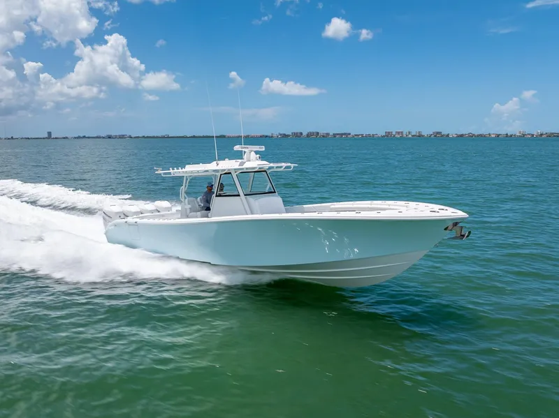 Slide: The Image of 2023 Yellowfin 39 Offshore boat cruising on open water under a clear blue sky. - 24