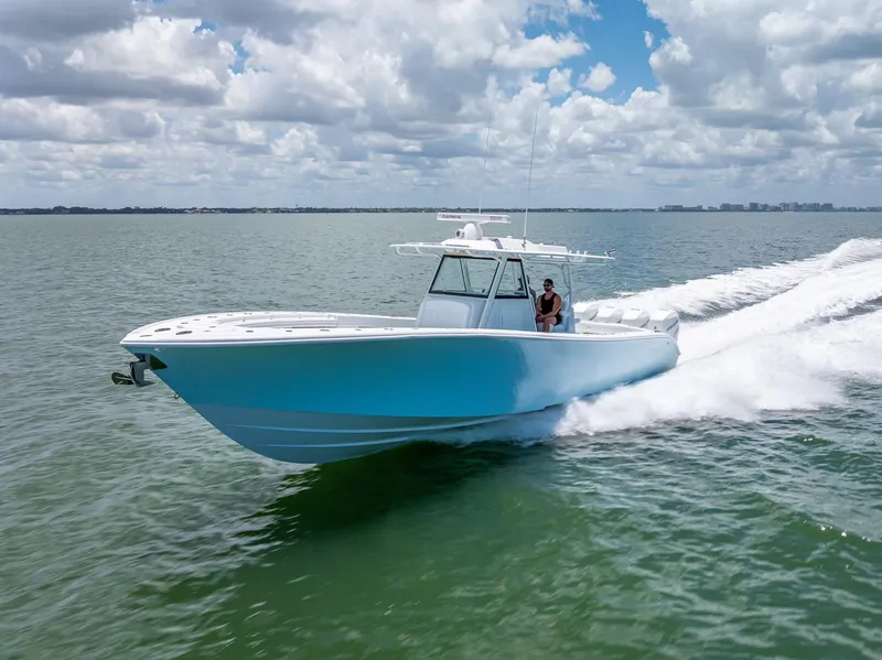 Slide: The Image of 2023 Yellowfin 39 Offshore boat cruising on open water under a cloudy sky. - 25
