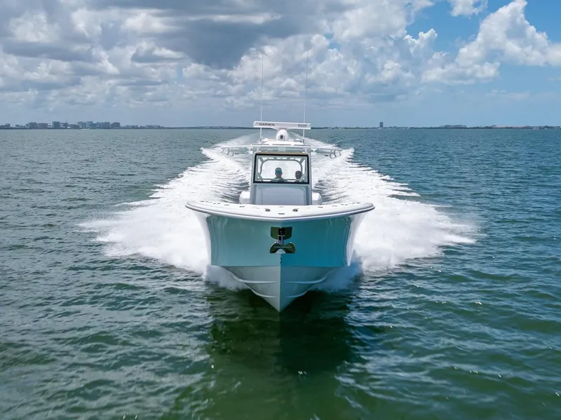 Slide: The Image of 2023 Yellowfin 39 Offshore boat cruising on open water under a partly cloudy sky. - 26