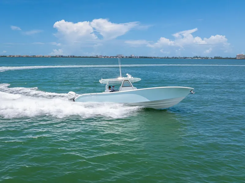 Slide: The Image of 2023 Yellowfin 39 Offshore boat cruising on open water under a clear blue sky. - 28