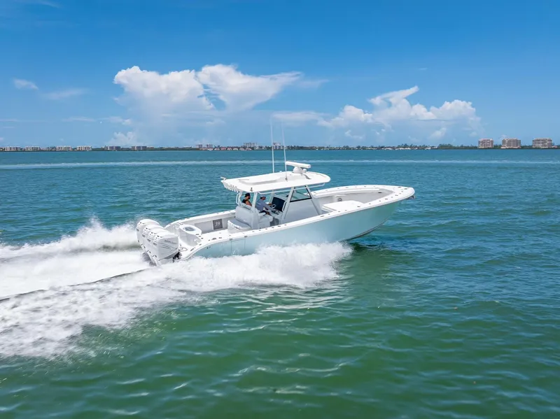 Slide: The Image of 2023 Yellowfin 39 Offshore boat cruising on open water under a clear blue sky. - 29