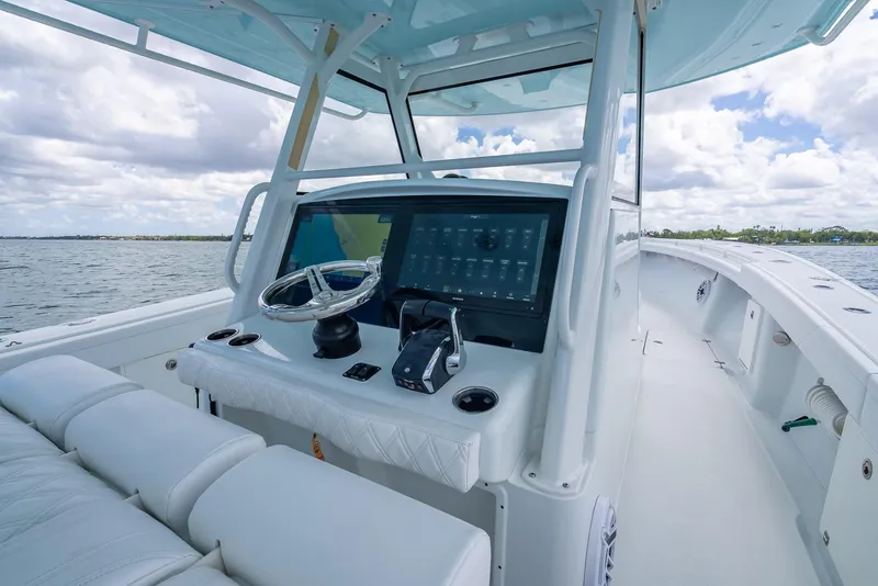 Slide: The Image of 2023 Yellowfin 39 Offshore boat cockpit with modern controls and steering wheel. - 30
