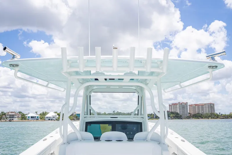 Slide: The Image of 2023 Yellowfin 39 Offshore boat on water, clear sky, and coastal buildings in background. - 33