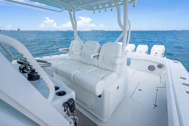 Slide: The Image of 2023 Yellowfin 39 Offshore boat interior with white seating, ocean view. - 36