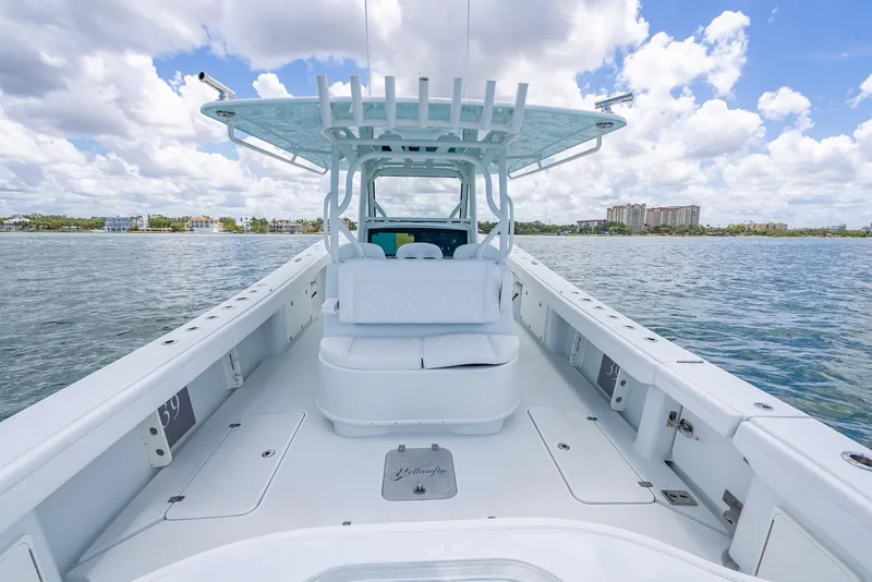 Slide: The Image of 2023 Yellowfin 39 Offshore boat on calm water under a partly cloudy sky. - 41