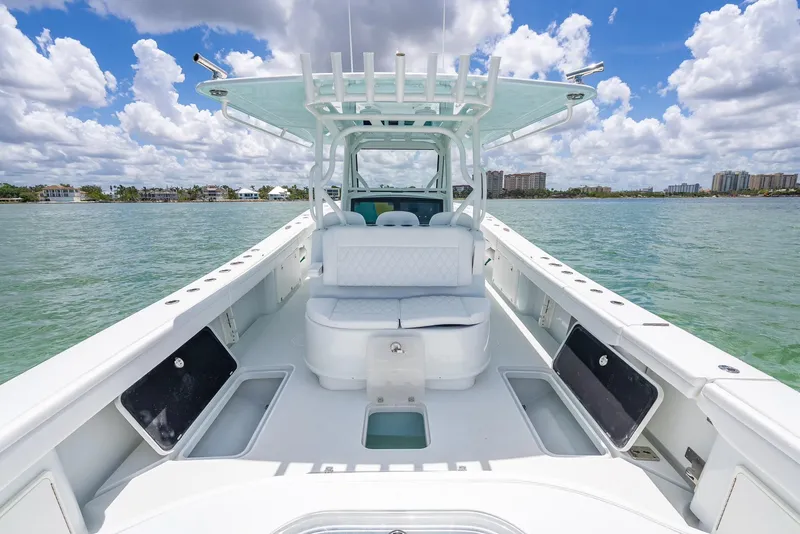 Slide: The Image of 2023 Yellowfin 39 Offshore boat on water, featuring spacious deck and seating under blue sky. - 42