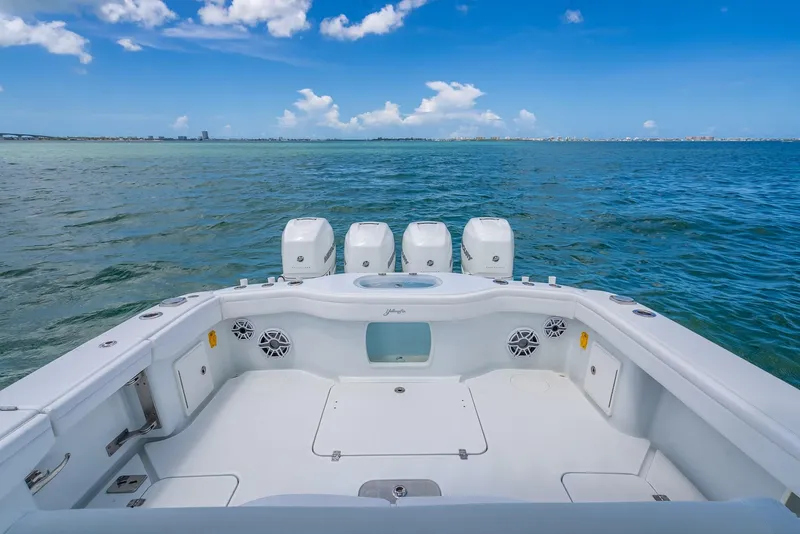 Slide: The Image of 2023 Yellowfin 39 Offshore boat on open water, featuring spacious deck and four engines. - 44