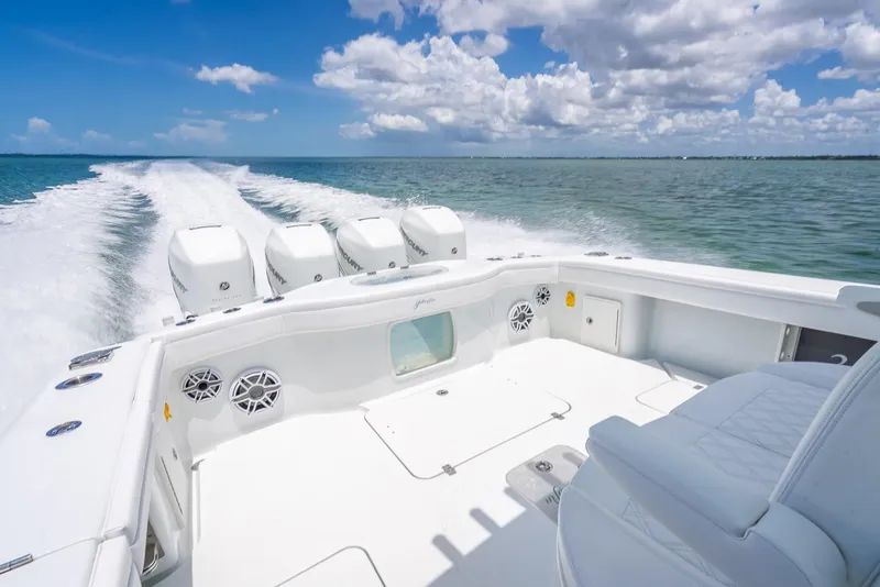 Slide: The Image of 2023 Yellowfin 39 Offshore boat cruising on open water under a partly cloudy sky. - 48
