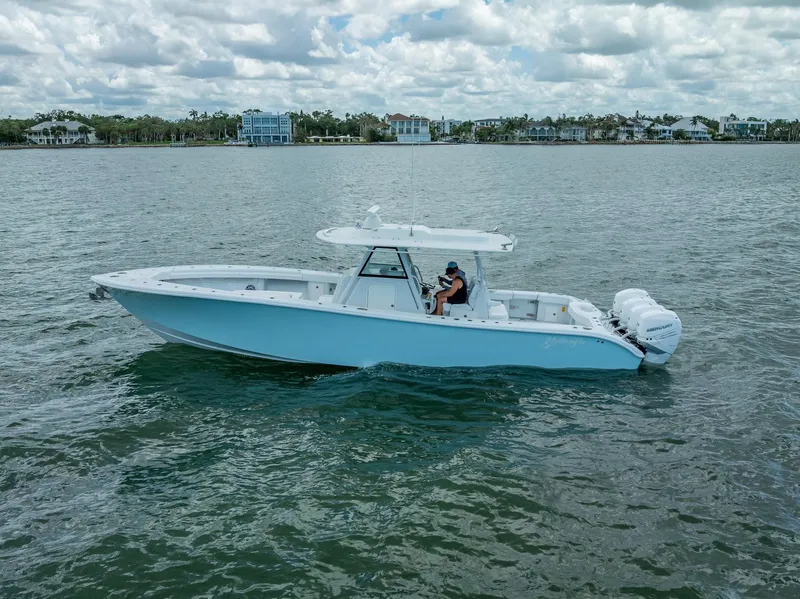 Slide: The Image of 2023 Yellowfin 39 Offshore boat cruising on a calm lake under a cloudy sky. - 7