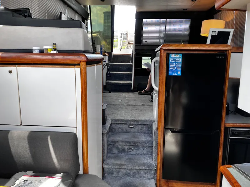 Slide: The Image of Interior of 1991 Bayliner 4387 Motoryacht with modern amenities and stylish wood accents. - 5