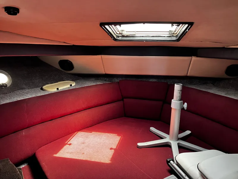 Slide: The Image of Interior of 1991 Bayliner 4387 Motoryacht with red seating and overhead hatch. - 6