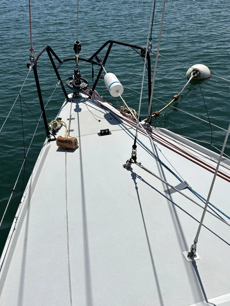 Slide: The Image of Bow of 2018 J Boats J/121 sailboat with rigging and calm water. - 10