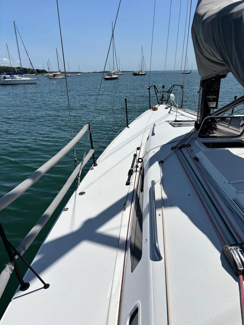 Slide: The Image of 2018 J Boats J/121 sailboat on calm water, with visible deck and rigging. - 12