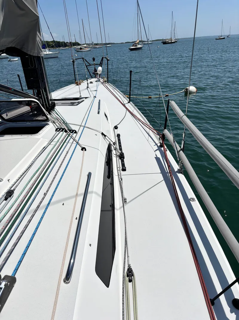 Slide: The Image of 2018 J Boats J/121 sailboat deck with rigging, moored in a calm harbor. - 13