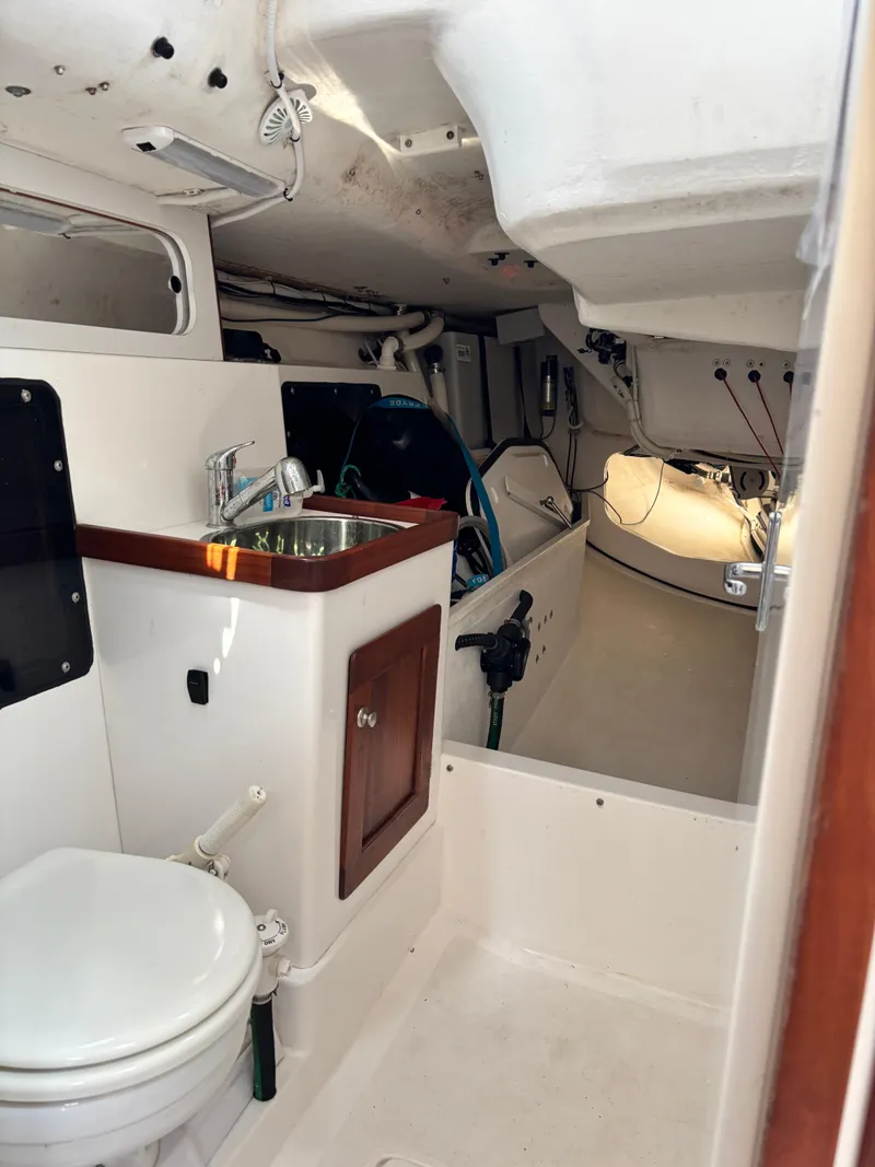 Slide: The Image of Interior of 2018 J Boats J/121 sailboat, featuring compact bathroom and sink area. - 24