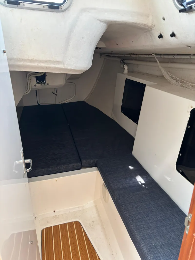 Slide: The Image of 2018 J Boats J/121 interior cabin with cushioned seating and wooden flooring. - 25