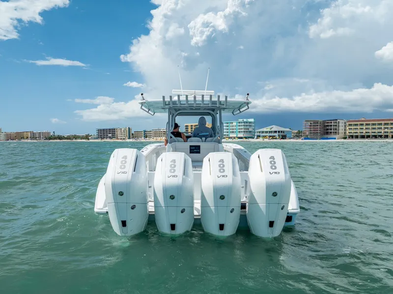 Slide: The Image of 2024 Yellowfin 39 boat with four powerful outboard engines on the water. - 11