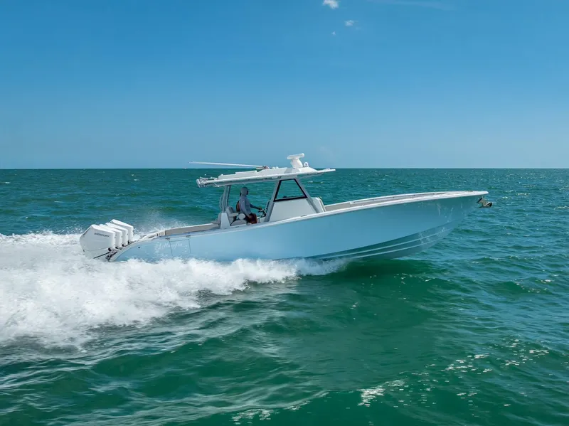 Slide: The Image of 2024 Yellowfin 39 boat cruising on open sea under clear blue sky. - 13