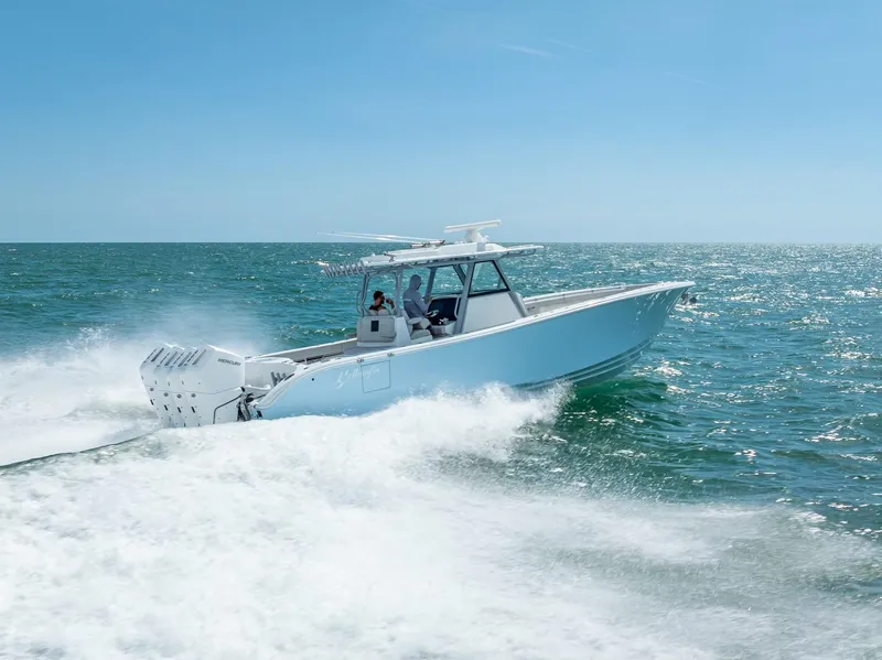 Slide: The Image of 2024 Yellowfin 39 boat cruising on open sea under clear blue sky. - 16