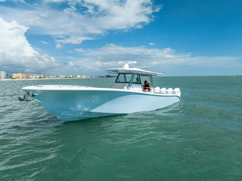 Slide: The Image of 2024 Yellowfin 39 boat cruising on open water under a clear blue sky. - 2