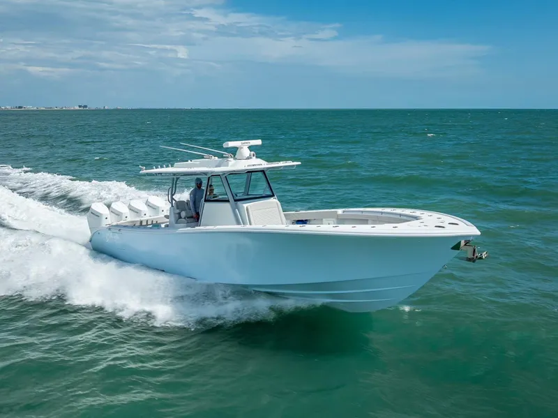 Slide: The Image of 2024 Yellowfin 39 boat cruising on open water under a clear blue sky. - 20