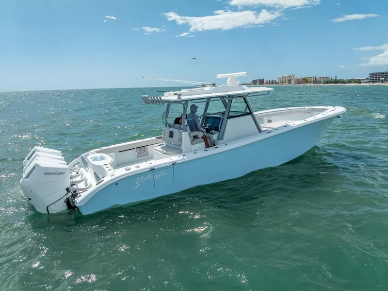 Slide: The Image of 2024 Yellowfin 39 boat cruising on open water under a clear blue sky. - 22