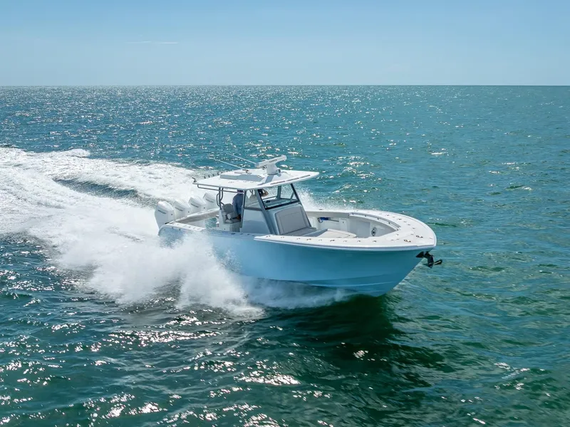 Slide: The Image of 2024 Yellowfin 39 boat cruising on open sea under clear blue sky. - 25