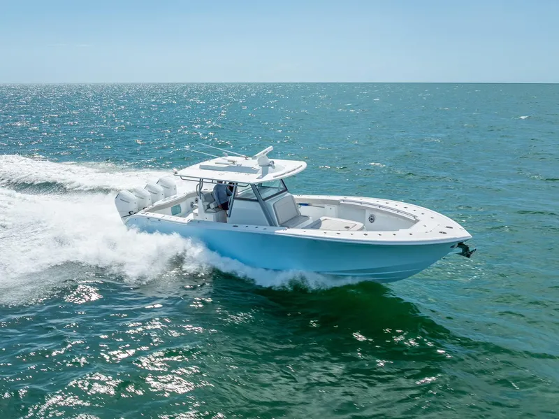 Slide: The Image of 2024 Yellowfin 39 boat cruising on open sea under clear blue sky. - 26