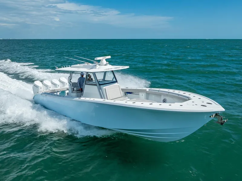 Slide: The Image of 2024 Yellowfin 39 boat cruising on open ocean under clear blue sky. - 27