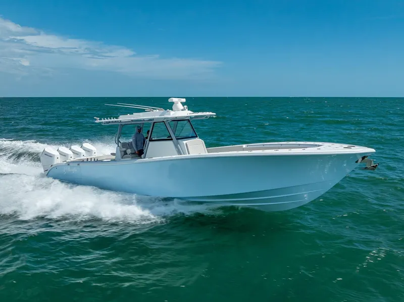 Slide: The Image of 2024 Yellowfin 39 boat cruising on open ocean under clear blue sky. - 28