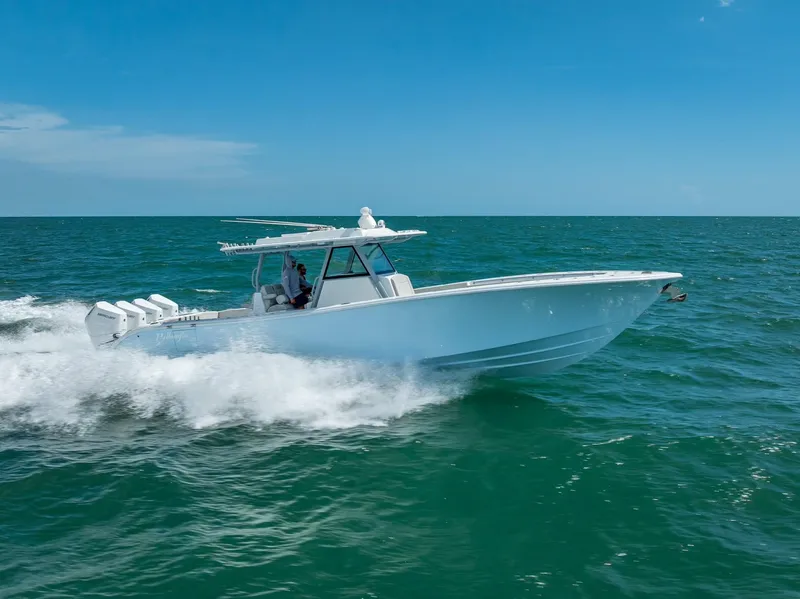 Slide: The Image of 2024 Yellowfin 39 boat cruising on open sea under clear blue sky. - 29