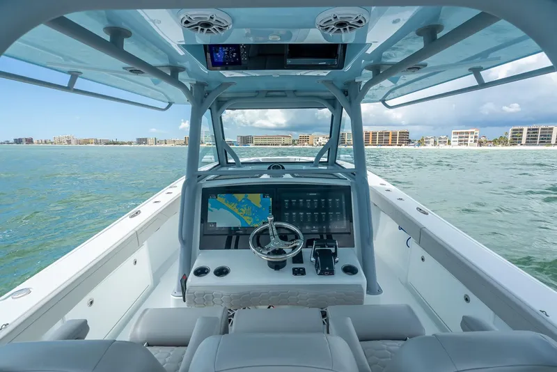 Slide: The Image of 2024 Yellowfin 39 boat cockpit with advanced navigation system on open water. - 30