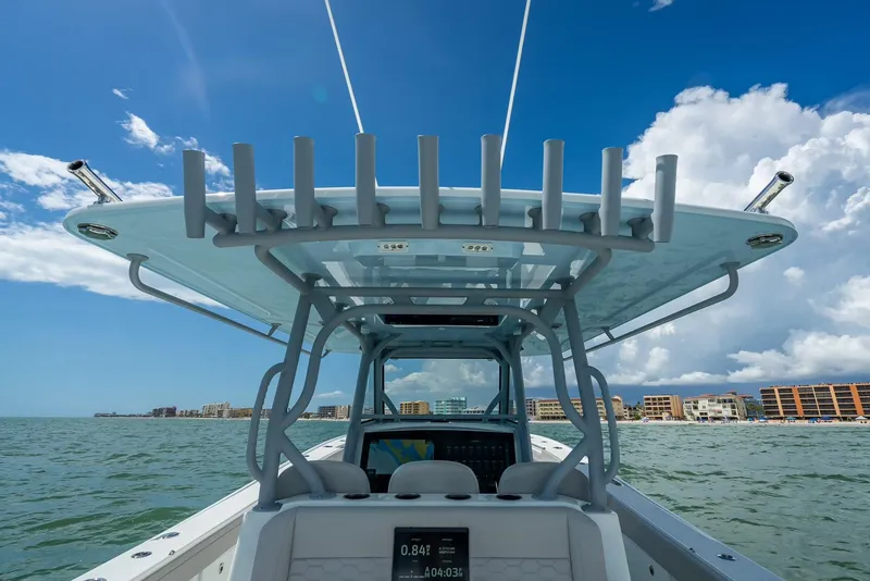 Slide: The Image of 2024 Yellowfin 39 boat on water, featuring modern helm and rod holders under a clear sky. - 36