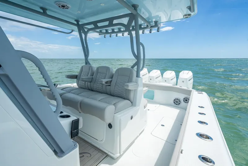 Slide: The Image of 2024 Yellowfin 39 boat interior with seating, ocean view, and multiple engines. - 38