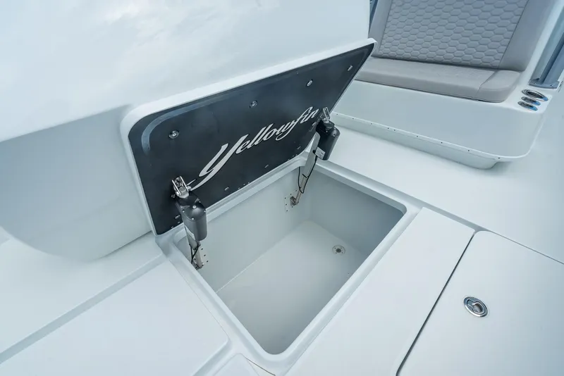 Slide: The Image of 2024 Yellowfin 39 boat storage compartment with open lid, showcasing interior space. - 48